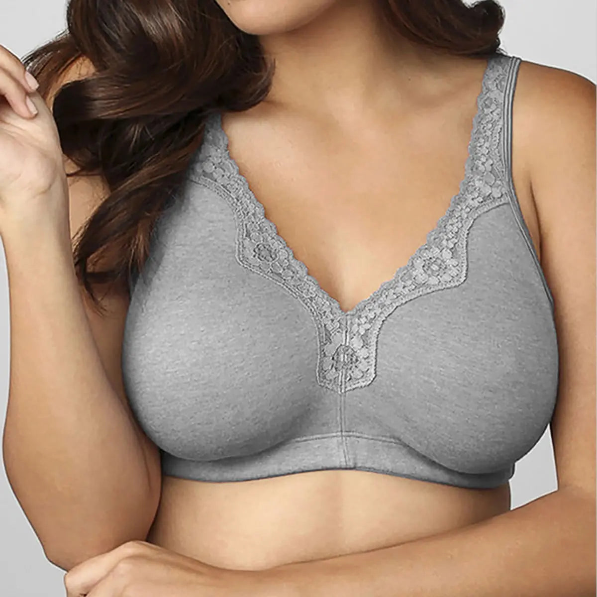 Gray bra with lace trim worn by a model on a plain background