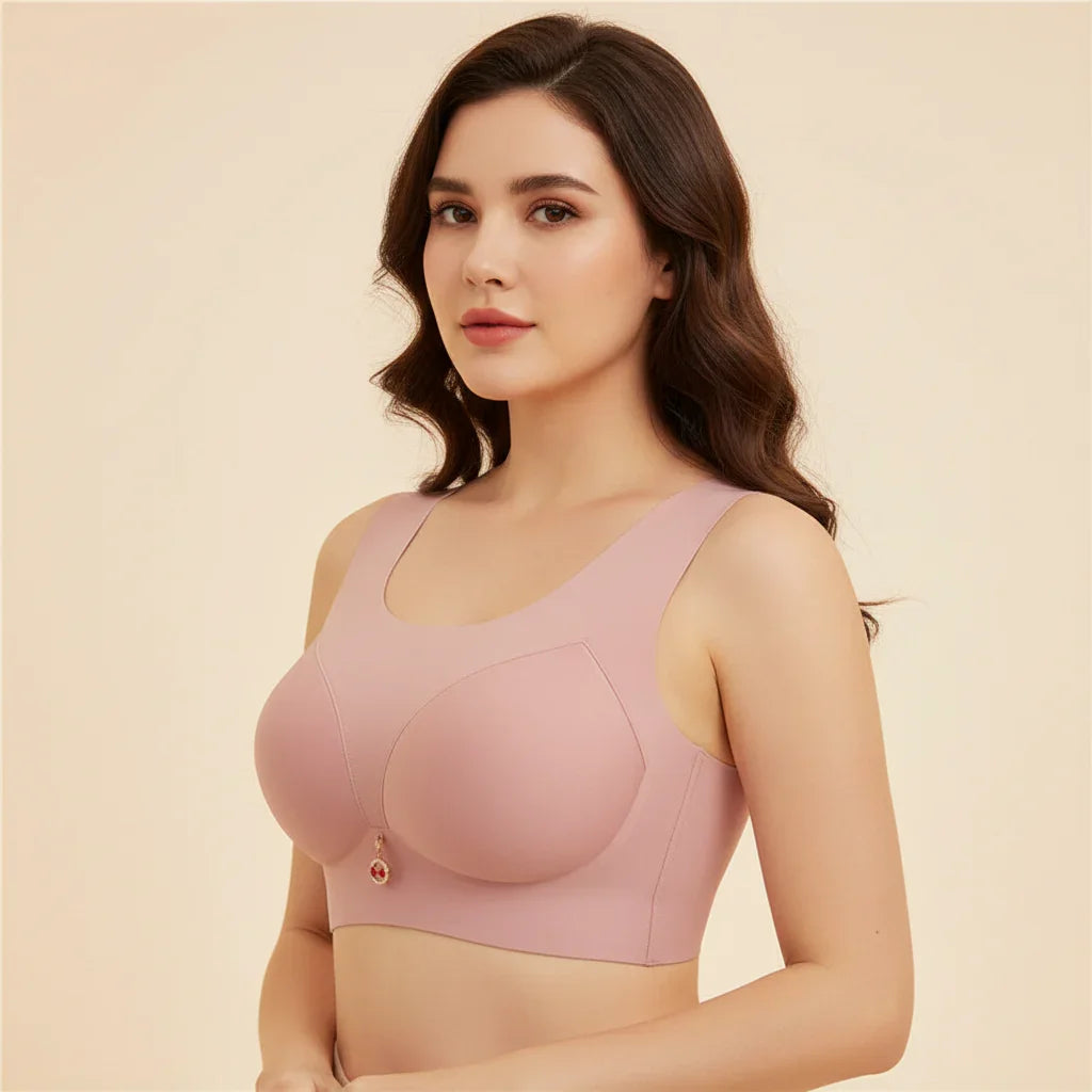 Woman wearing a pink bralette against a beige background