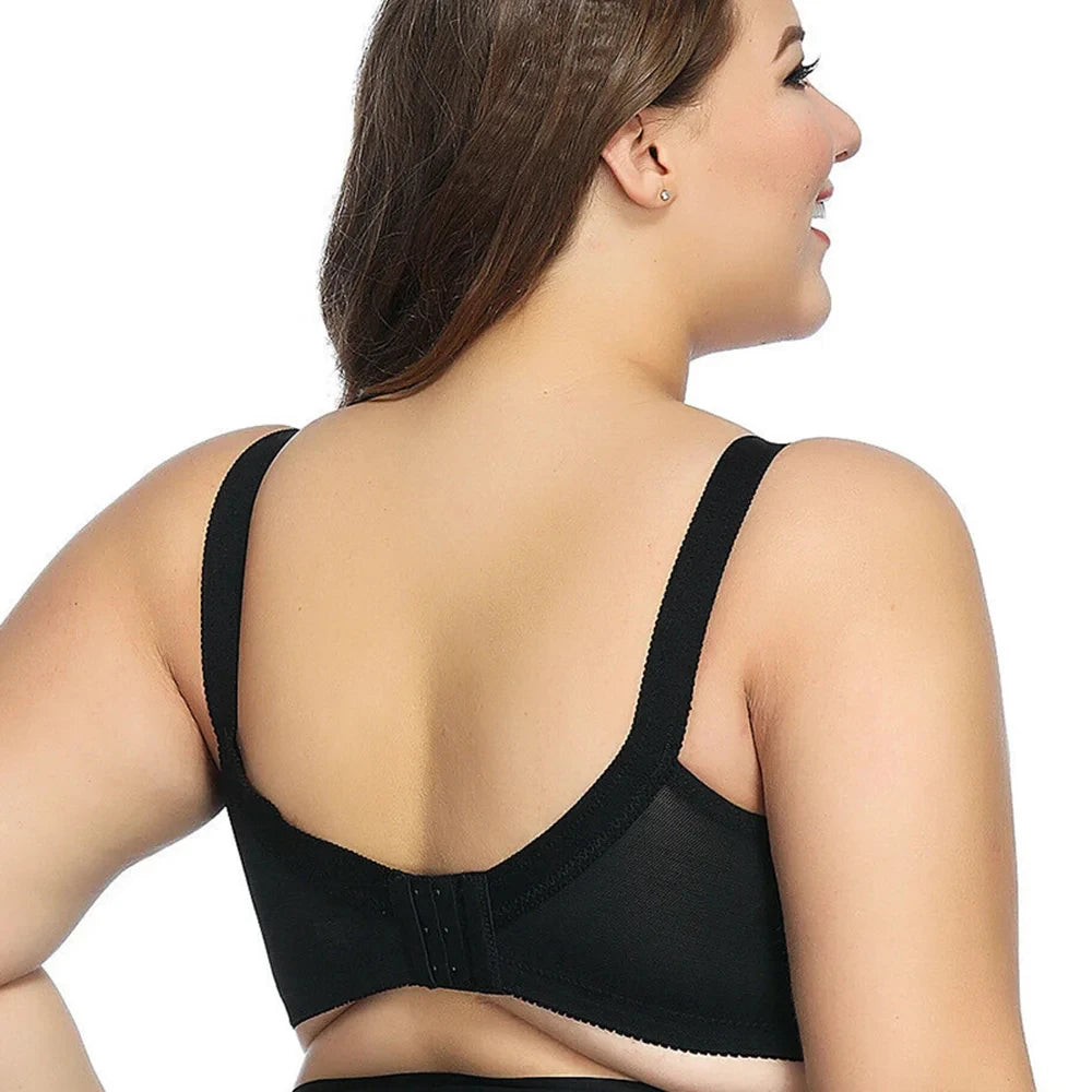 Woman wearing a black back support brace on a white background