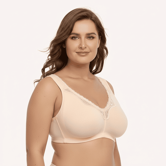 Woman wearing a beige bra on a plain background