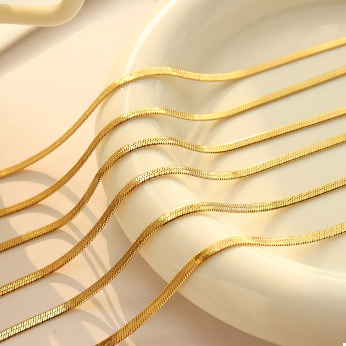 Gold chains on a beige background